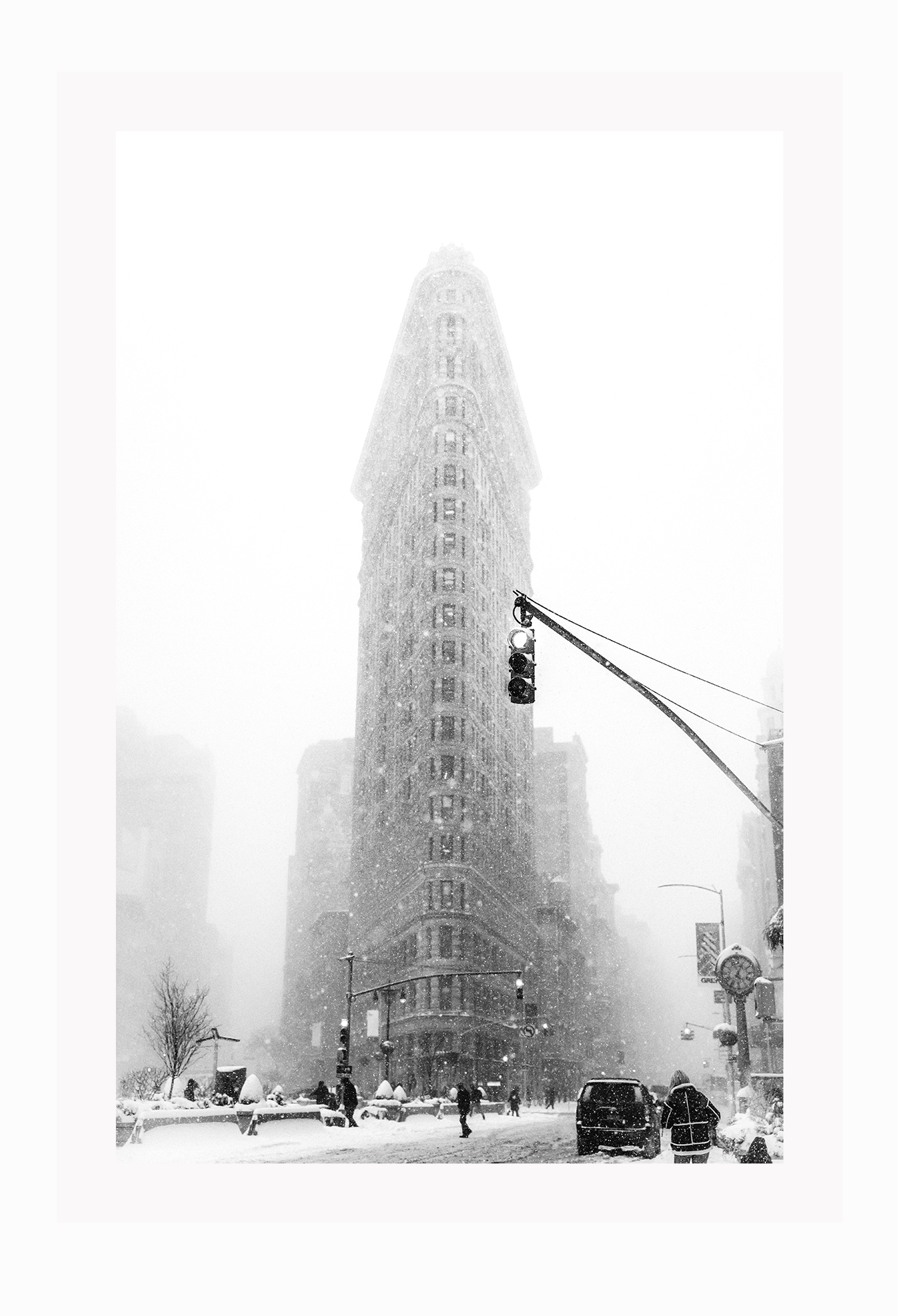 A black and white urban wall art with a snowy city street corner in winter