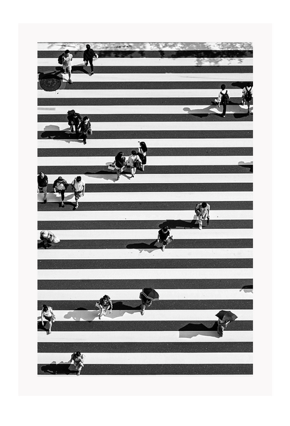 A black and white urban wall art with an aerial view of a busy city street crossing with zebra stripes.