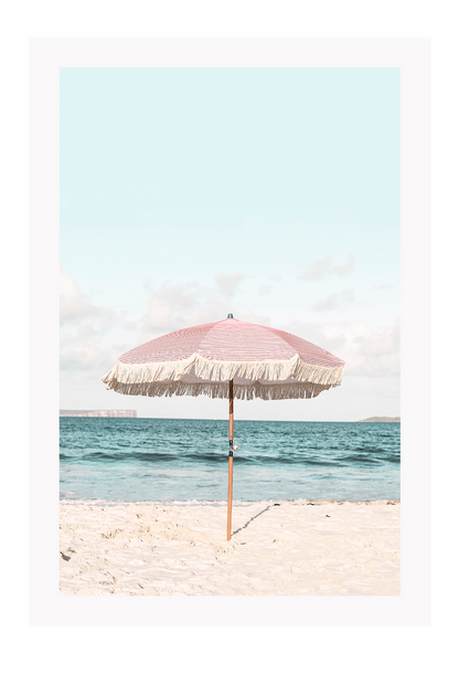 A natural wall art with a pink umbrella on the summer beach in Bali pastel tones and boho style