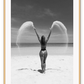 Sexy lady woman throwing sand on a beach in black and white, coastal ocean. 