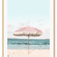 A natural wall art with a pink umbrella on the summer beach in Bali pastel tones and boho style