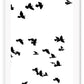 A black and white wall art with black sky birds in white sky. 